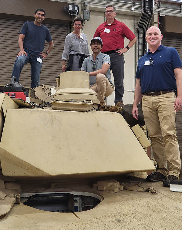 photo of three researcher working outdoors on a tablet